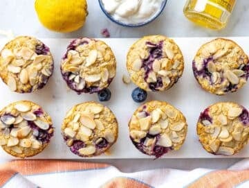 Step 4 Baked oatmeal cups cooling on marble table with golden tops.