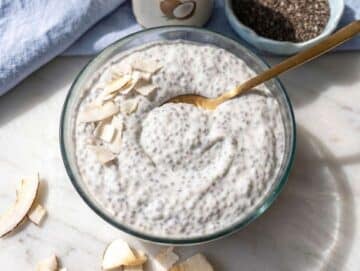 Step 4 Coconut chia pudding with thick creamy texture and spoon on marble surface.