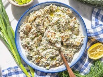Step 4 Roasted potatoes being gently tossed with creamy dressing and served in a bowl.