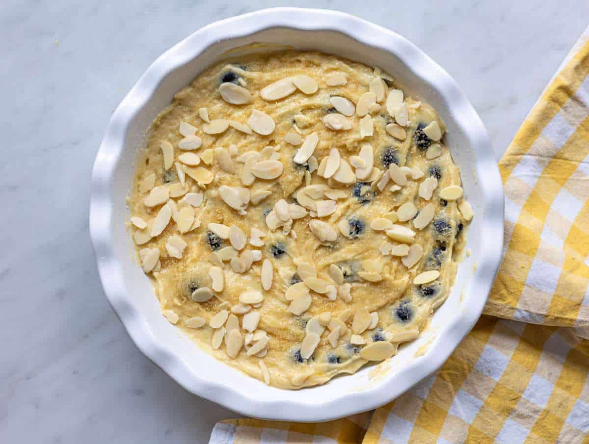 Step 4 Thick batter spooned over blueberries in a pie dish.