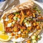 Vegetable shawarma served on warmed pita with simple fresh toppings.