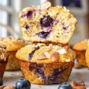 Blueberry protein muffin split open to show soft crumb and juicy blueberries inside.