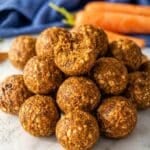 Carrot cake energy balls made with oats, carrots, and walnuts in bright natural window light.