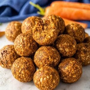 Carrot cake energy balls made with oats, carrots, and walnuts in bright natural window light.