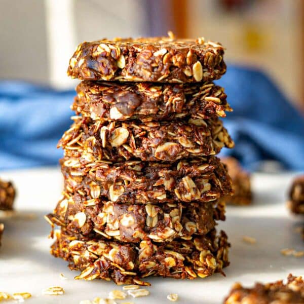 Chocolate oatmeal no bake cookies stacked on a plate.