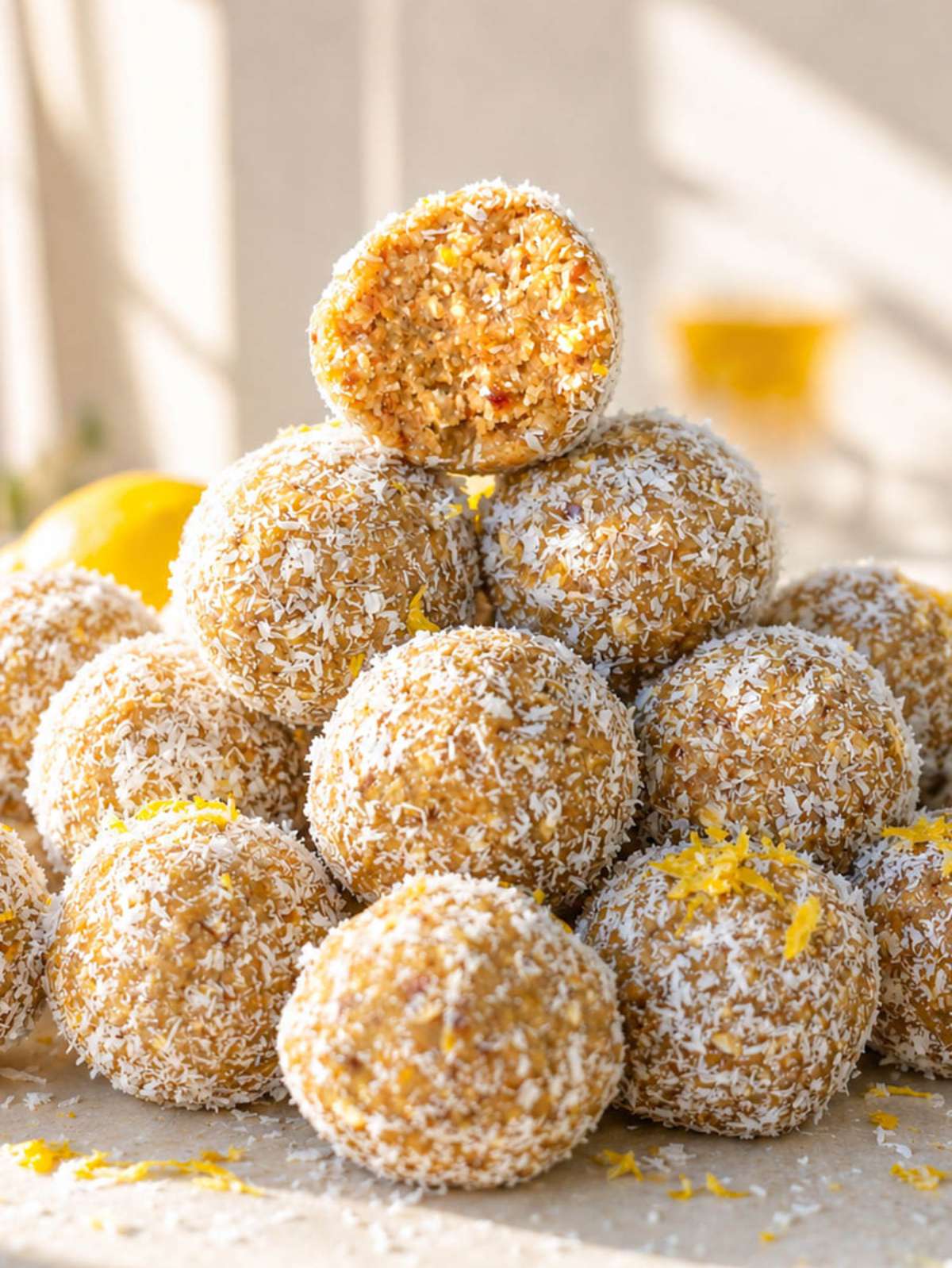 Close-up Lemon Energy Balls showing soft oat and date texture under natural window light.