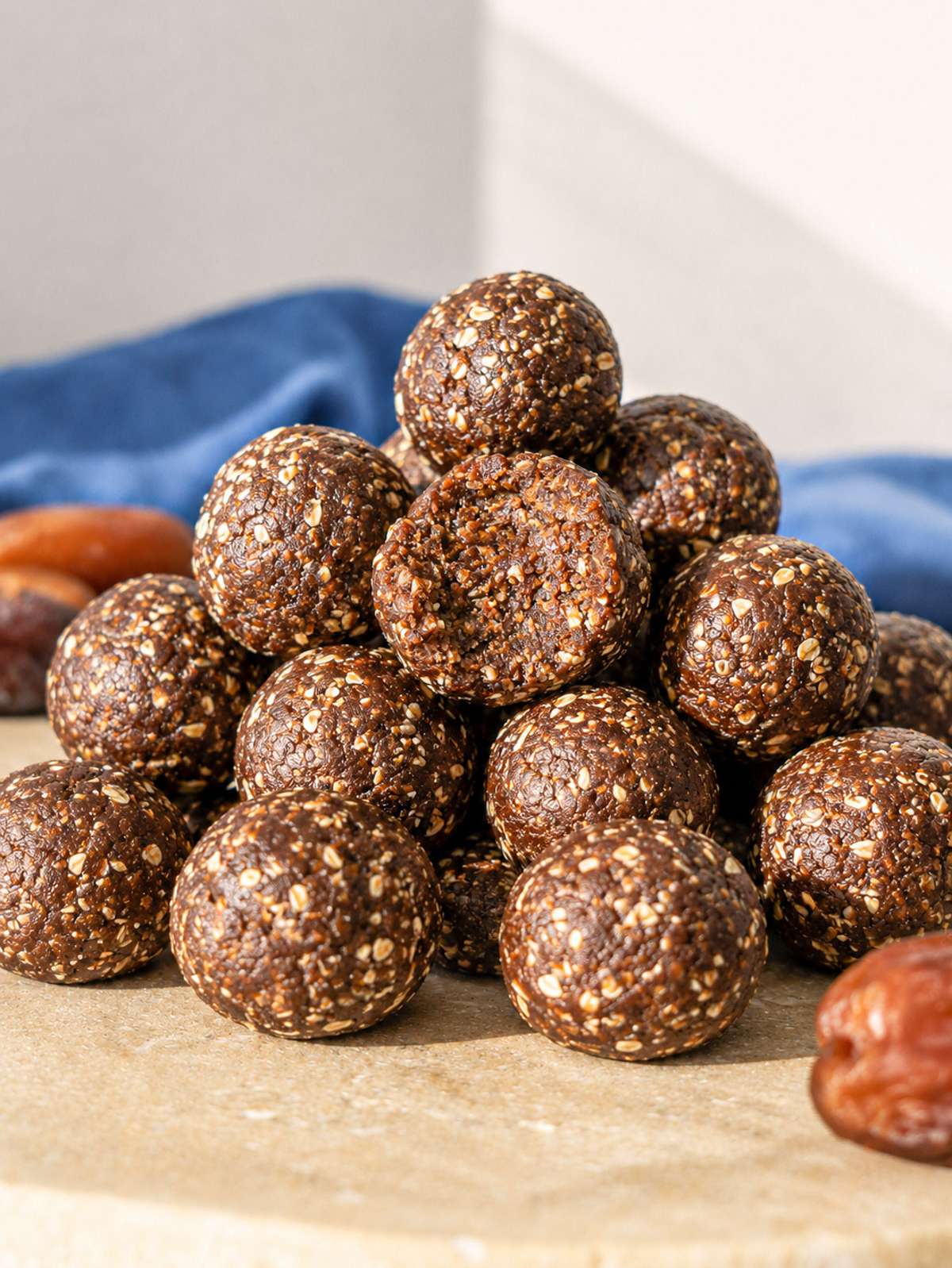 Close-up of soft chewy date energy ball broken open to show texture.