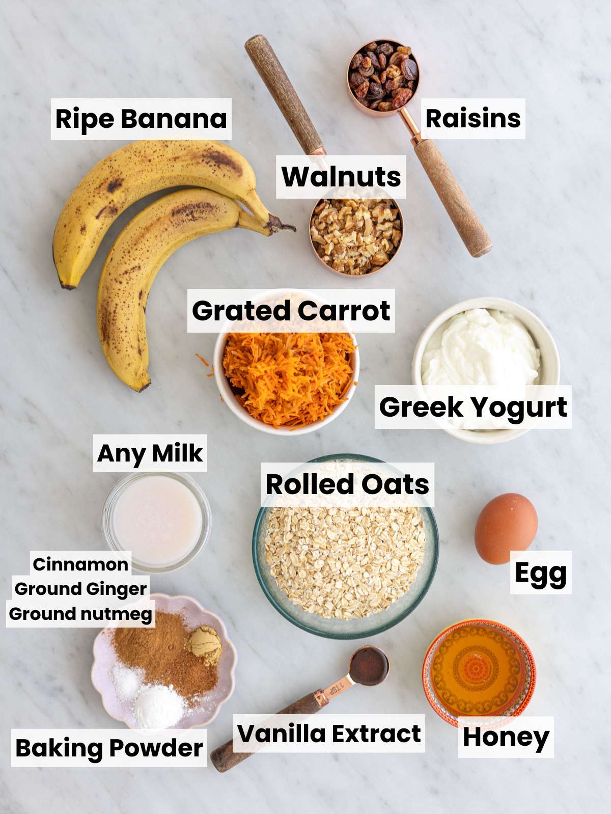 Ingredients for carrot cake baked oatmeal arranged on marble surface.