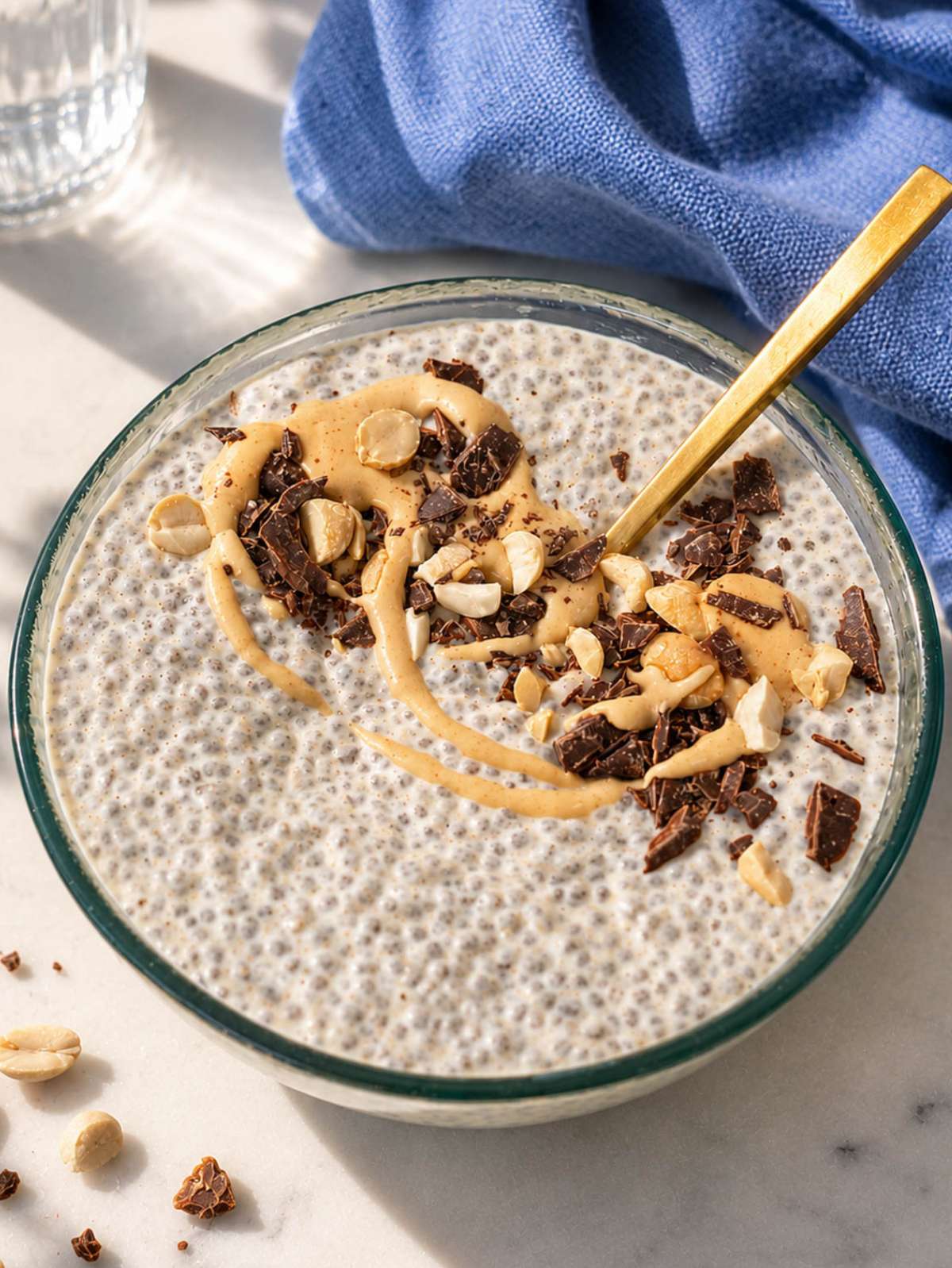 Peanut butter chia pudding topped with peanut butter drizzle and crushed peanuts.