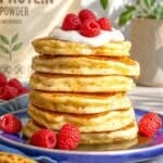 Protein banana pancakes topped with yogurt, raspberries, and maple syrup.