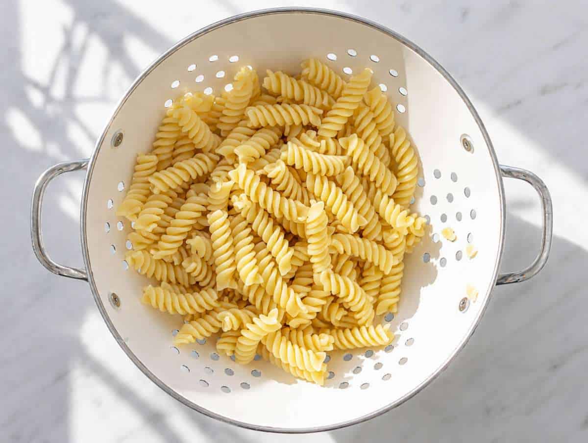 Step 1 Cooked pasta cooling in colander.