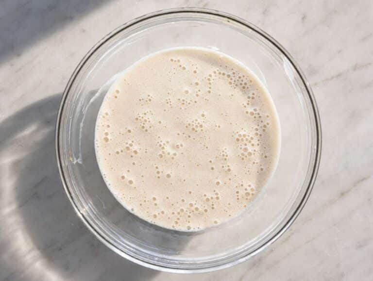 Step 1 Peanut butter, milk, maple syrup, and chia seeds added to a glass mixing bowl.