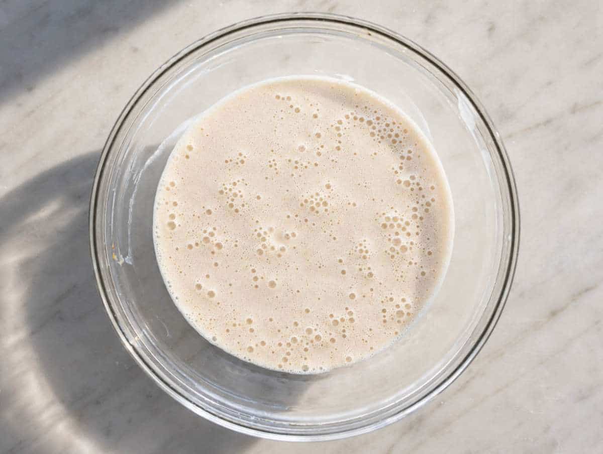 Step 1 Peanut butter, milk, maple syrup, and chia seeds added to a glass mixing bowl.