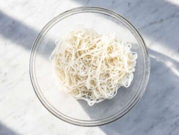 Step 1 Rice noodles in a large mixing bowl.