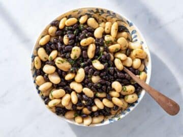 Step 2 Black beans and butter beans coated in smoky lime dressing inside mixing bowl.