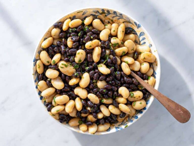 Step 2 Black beans and butter beans coated in smoky lime dressing inside mixing bowl.