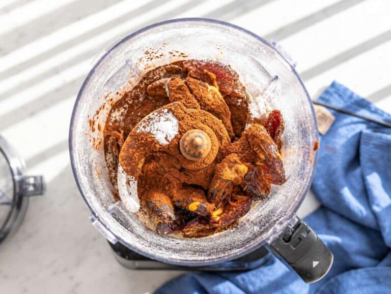 Step 2 Dates, peanut butter, cocoa powder, and oats inside food processor bowl.