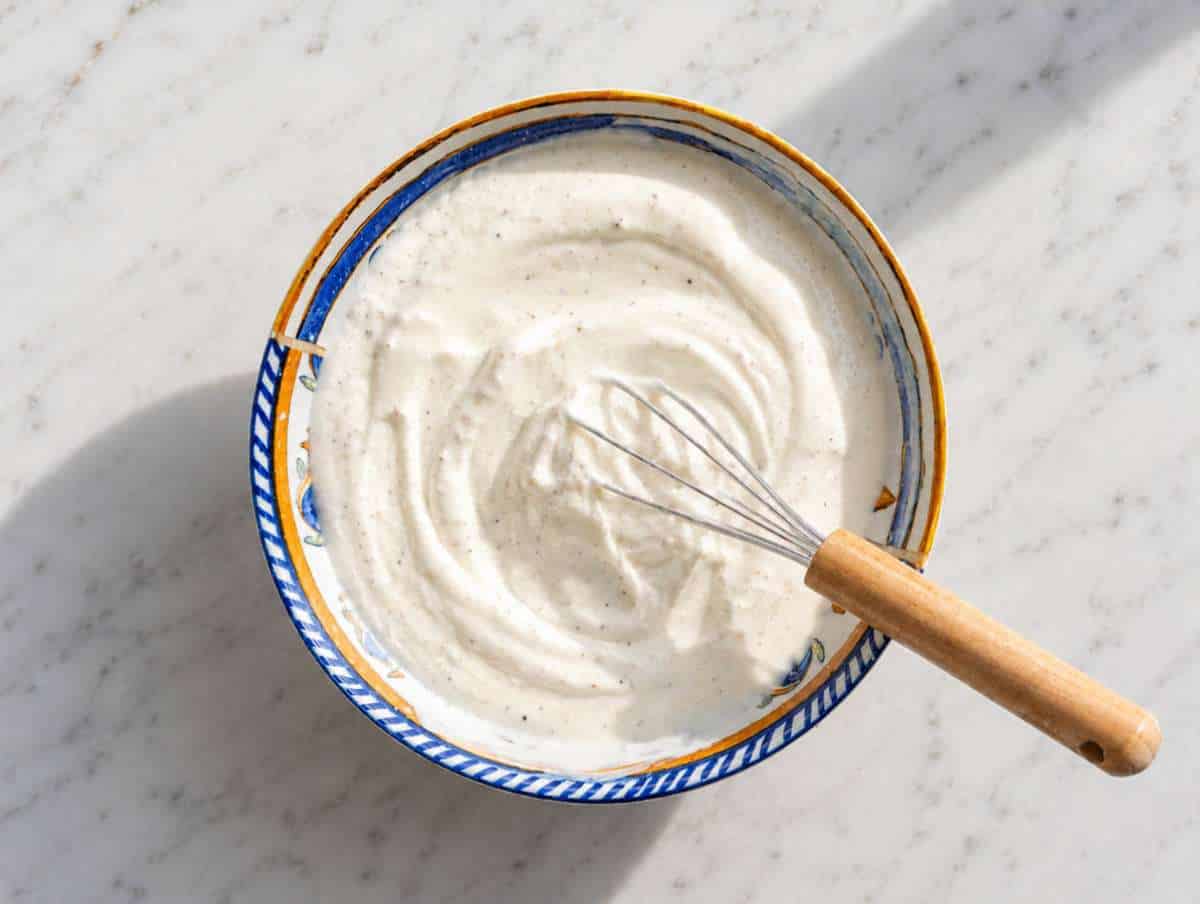 Step 2 Greek yogurt dressing whisked in a small bowl with mustard and vinegar.