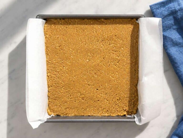 Step 2 Peanut butter oat mixture pressed into parchment-lined baking pan.