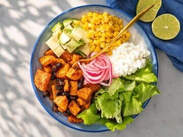 Step 3 Lettuce, avocado, roasted vegetables, and toppings arranged in serving bowl.