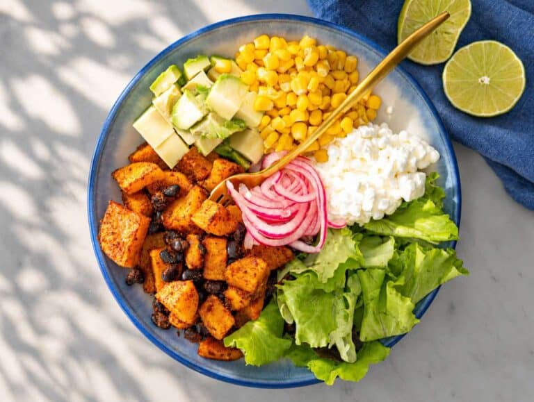 Step 3 Lettuce, avocado, roasted vegetables, and toppings arranged in serving bowl.