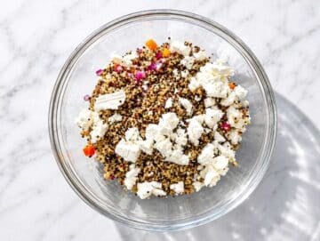 Step 3 Quinoa, corn, bell pepper, red onion, and feta layered in large salad bowl.