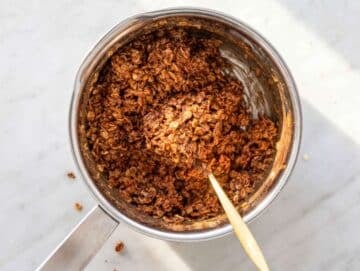 Step 3 Rolled oats folded into thick chocolate peanut butter mixture in a saucepan.