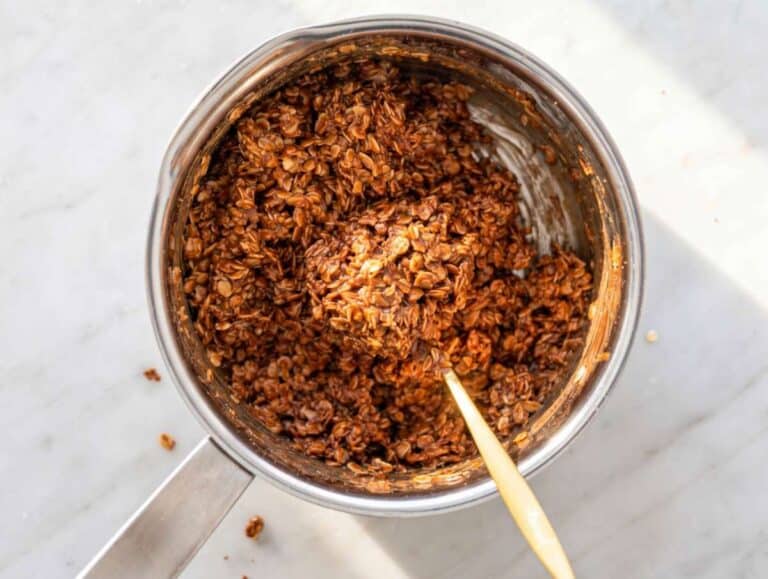 Step 3 Rolled oats folded into thick chocolate peanut butter mixture in a saucepan.