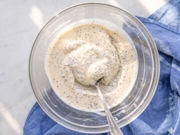 Step 3 Set protein chia pudding stirred in glass bowl with creamy texture visible.