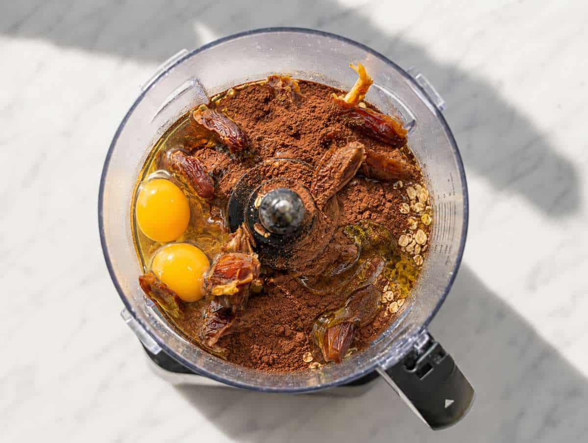 Step 3 oats, dates, eggs, olive oil, and cocoa powder in a food processor.