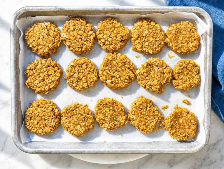 Step 4 Cookie mixture scooped onto parchment-lined tray and flattened with a fork.