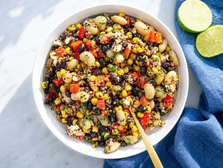 Step 4 Mexican bean salad tossed with dressing in a bowl.