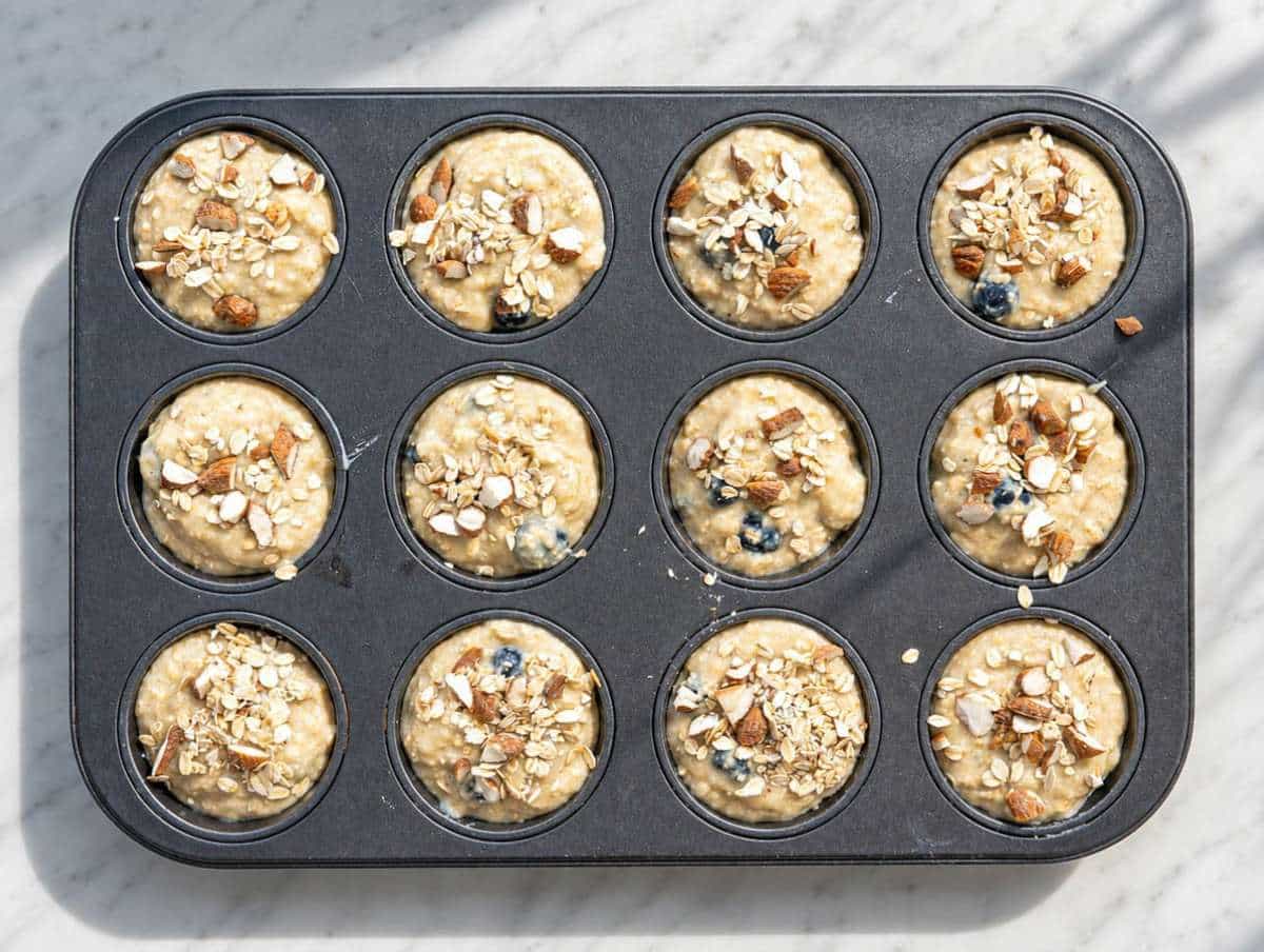 Step 4 Muffin pan filled with thick blueberry batter.