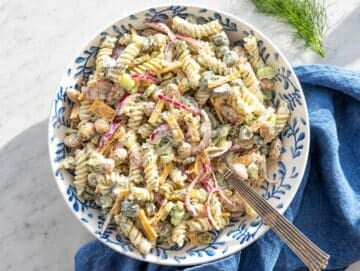 Step 4 Tossing pasta salad with creamy dressing in large mixing bowl.
