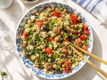 Step 5 Tossing Greek farro salad with feta, olives, chickpeas, and fresh vegetables.