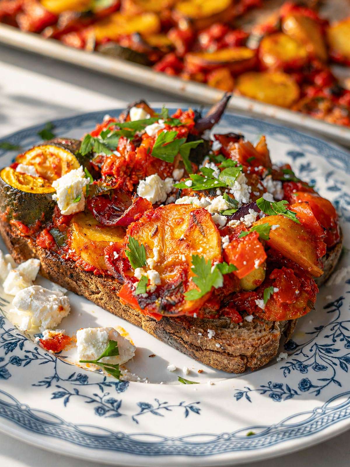 Briam served on toasted bread with feta and parsley.