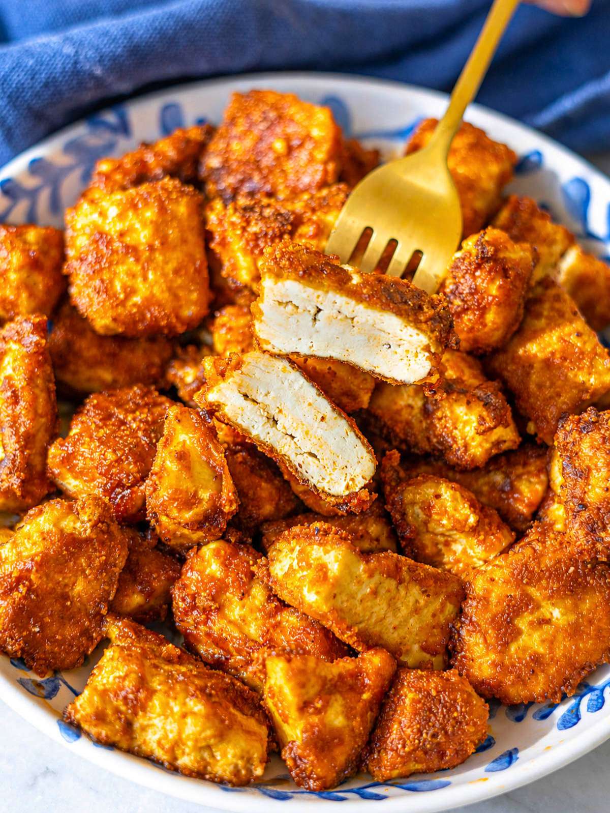 Close-up of crispy fried tofu chunks.