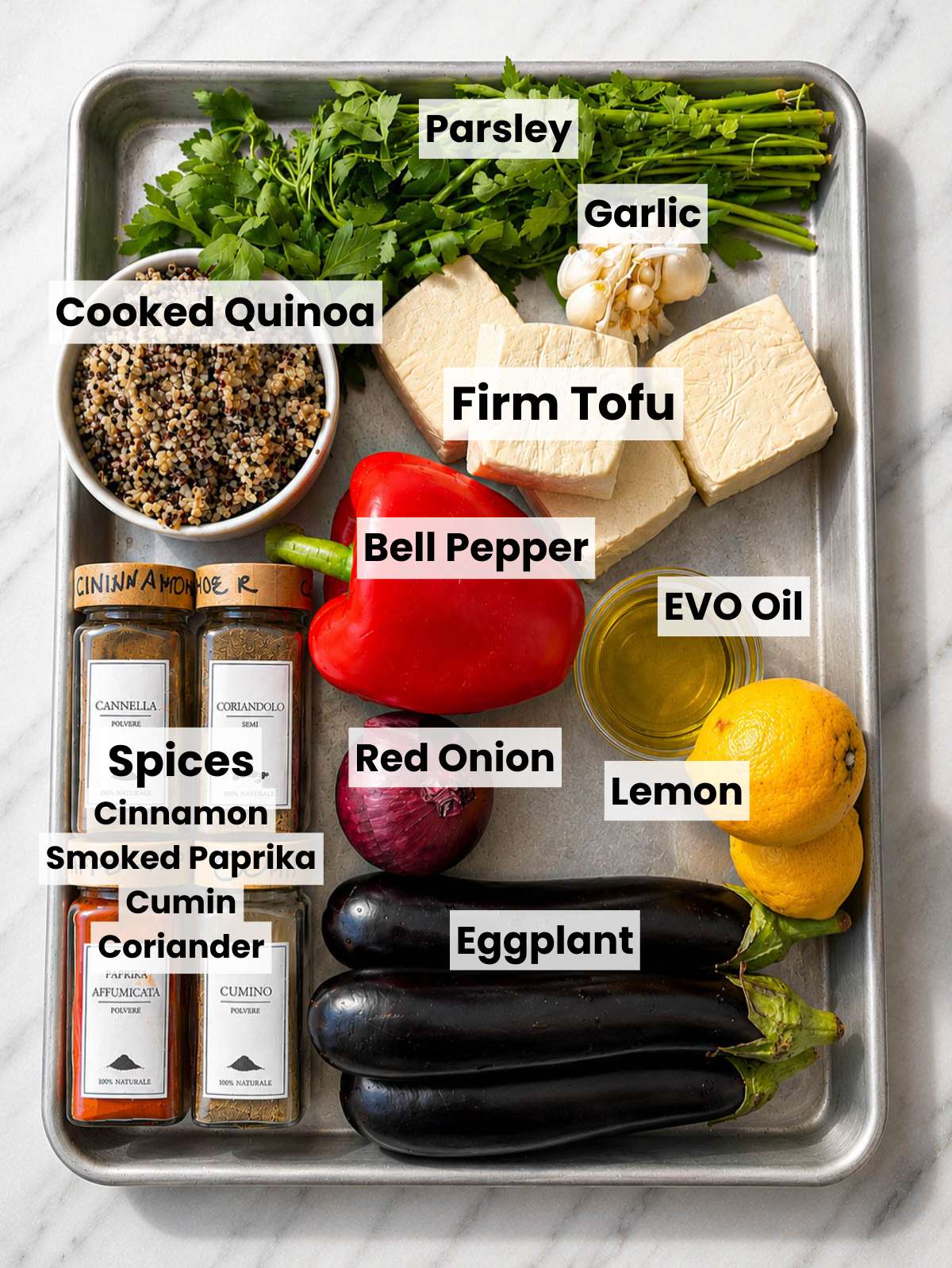 Firm tofu, vegetables, quinoa, spices on marble.