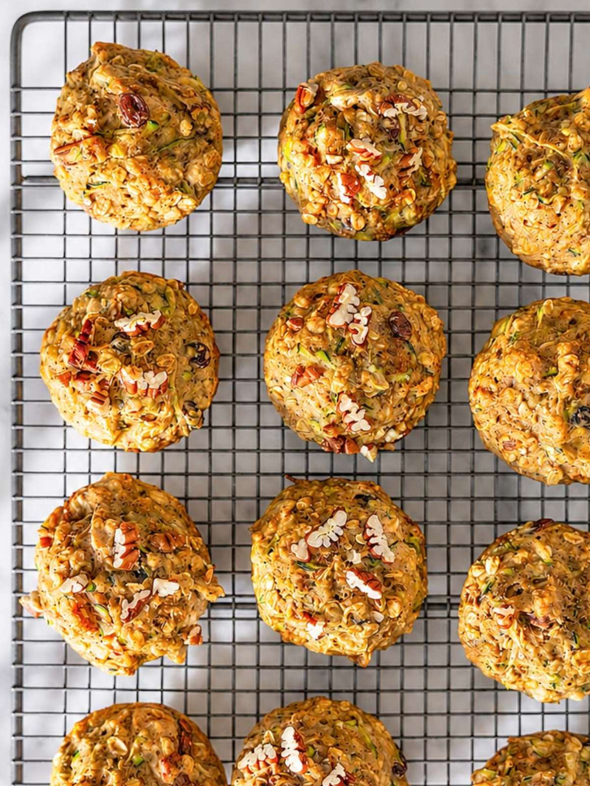 Freshly baked zucchini muffins cooling on rack.