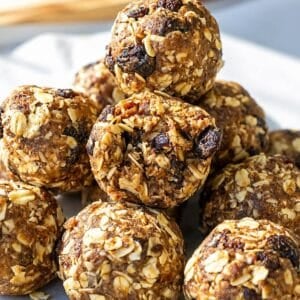 Homemade oatmeal raisin energy balls on marble surface.