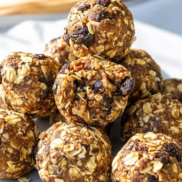 Homemade oatmeal raisin energy balls on marble surface.