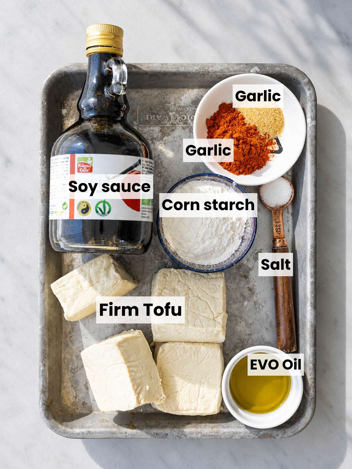 Ingredients for crispy fried tofu on marble.