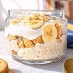 Jar of banana pudding overnight oats in natural window light.