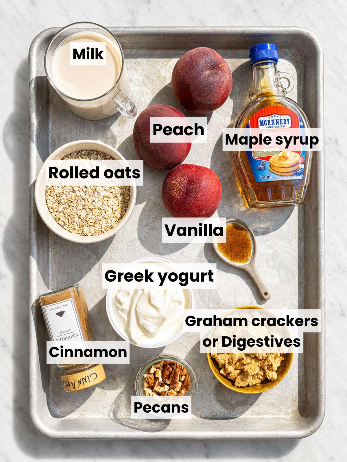 Measured ingredients for peach cobbler overnight oats on marble countertop.