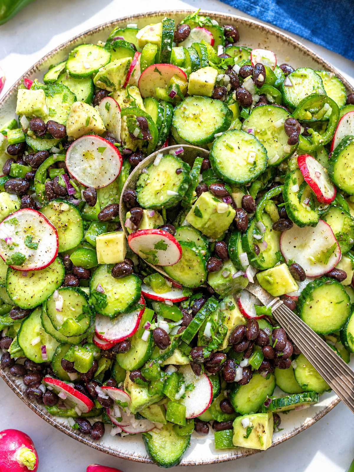 Mexican cucumber salad with avocado, black beans, and lime vinaigrette.