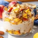 Peach cobbler overnight oats topped with peaches and crumble.