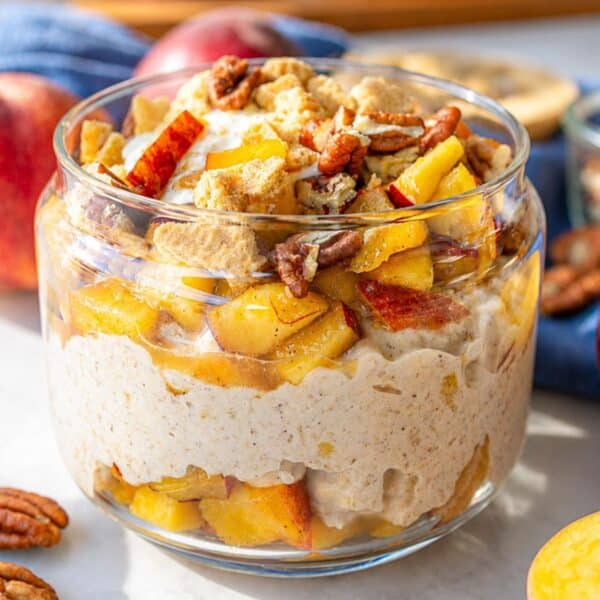 Peach cobbler overnight oats topped with peaches and crumble.