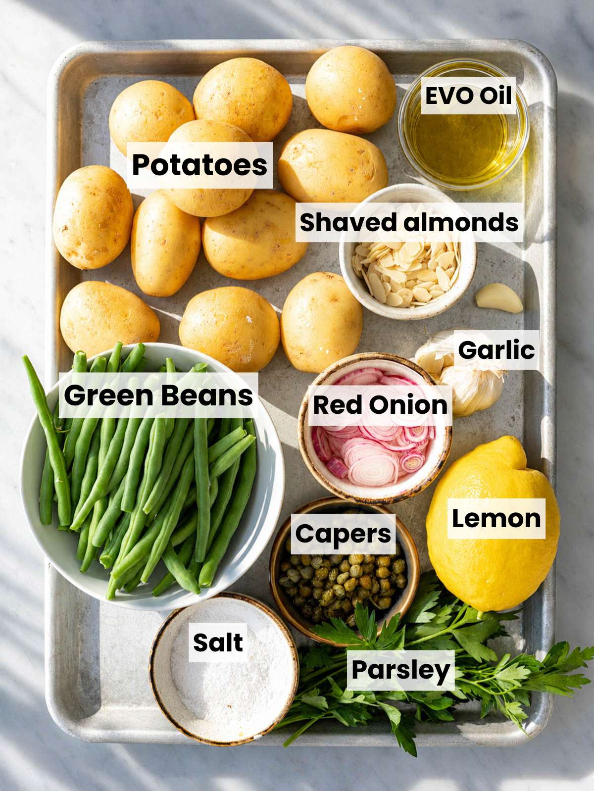 Potato salad ingredients on marble countertop.
