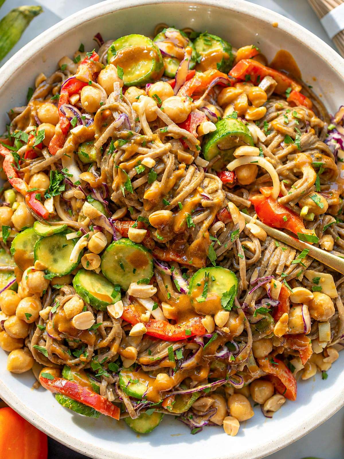 Soba noodle salad with chickpeas, vegetables, herbs, and peanuts.