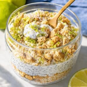 Spoon with creamy key lime pie chia pudding from glass jar.